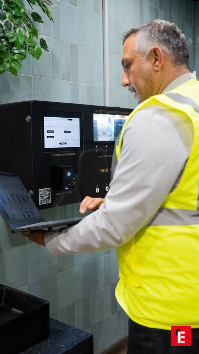 technician using laptop at fragrance kiosk