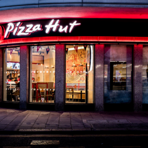 pizza hut storefront at night with neon sign