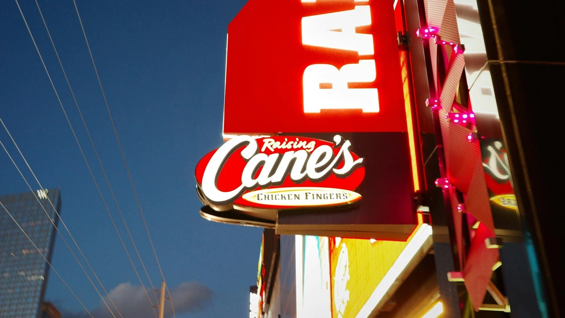 enseigne raising cane’s au crépuscule urbain