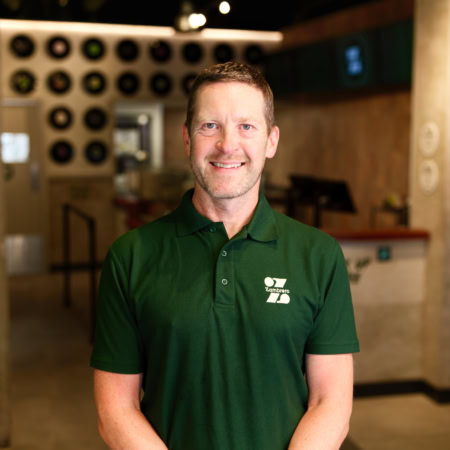 smiling zambrero employee in green polo shirt