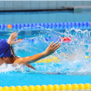 swimmer mid stroke in blue pool splash