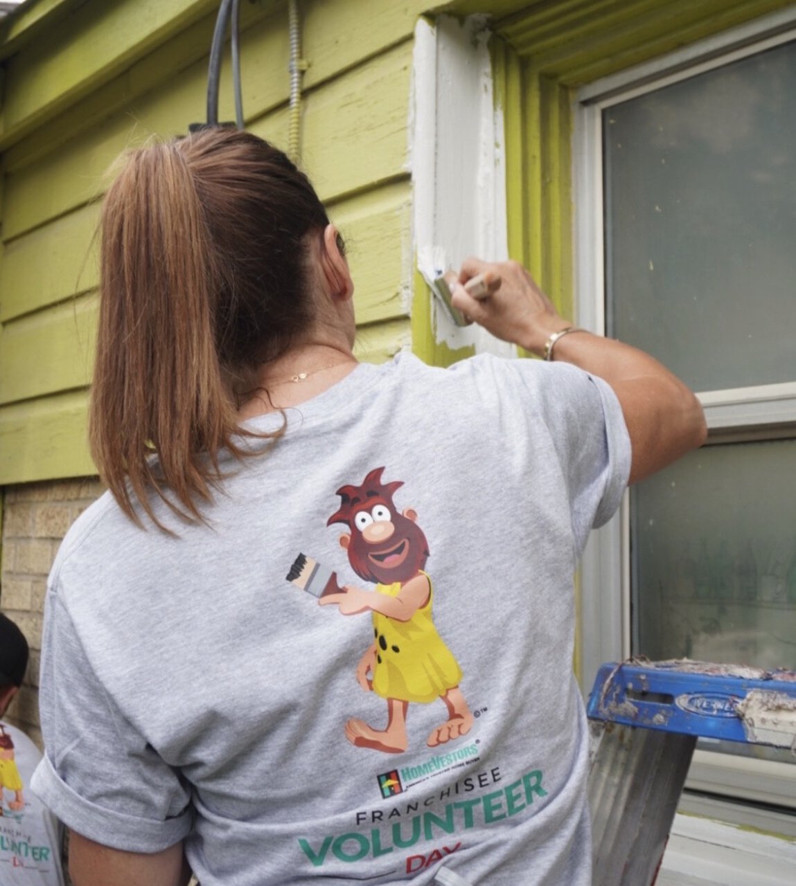 volunteer painting house exterior trim