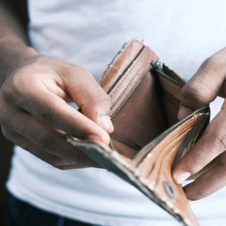 homme tenant portefeuille vide en cuir usé