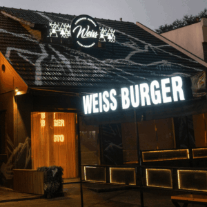 fachada nocturna iluminada de weiss burger