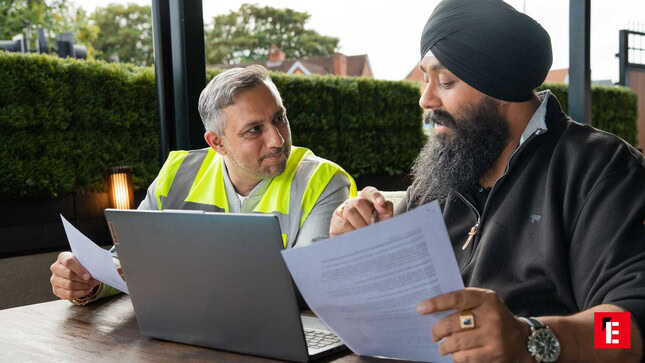 outdoor worksite meeting reviewing documents