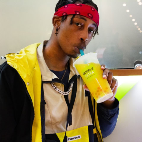 young man in streetwear sipping bubble tea