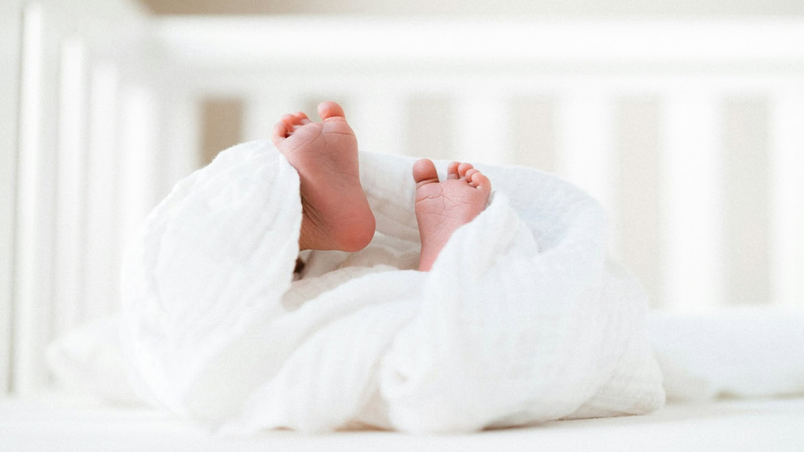 baby feet in soft white blankets