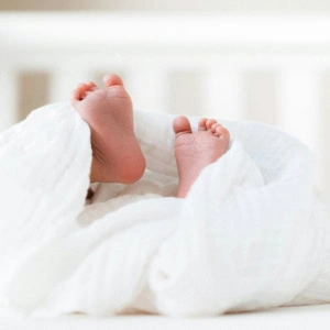 baby feet in soft white blankets