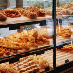 bakery display case with fresh breads and pastries