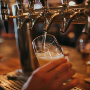 beer tap pouring golden lager in a bar