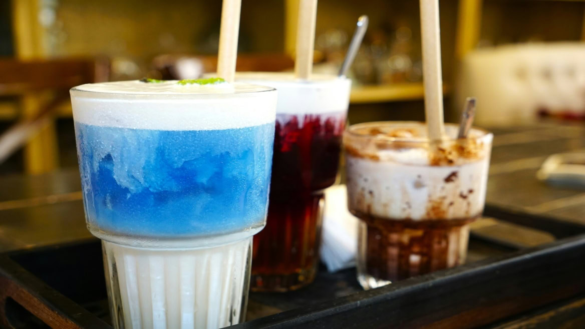 colourful dessert drinks tray in café glasses