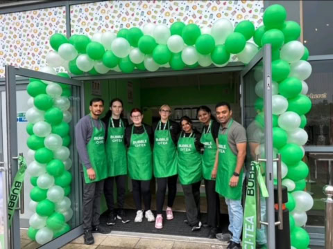 bubble ctea team photo at festive storefront