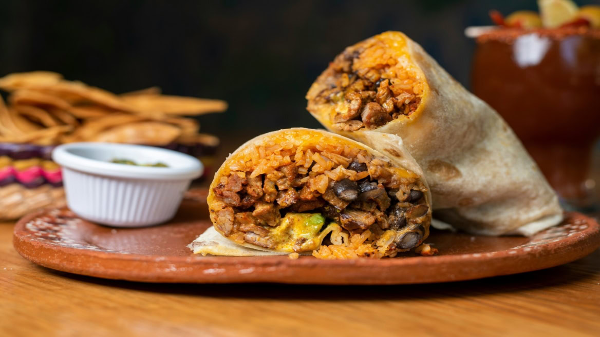 grilled burrito halves on rustic plate