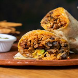 grilled burrito halves on rustic plate