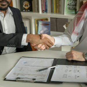 business handshake over contract signing