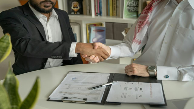 business handshake over contract signing