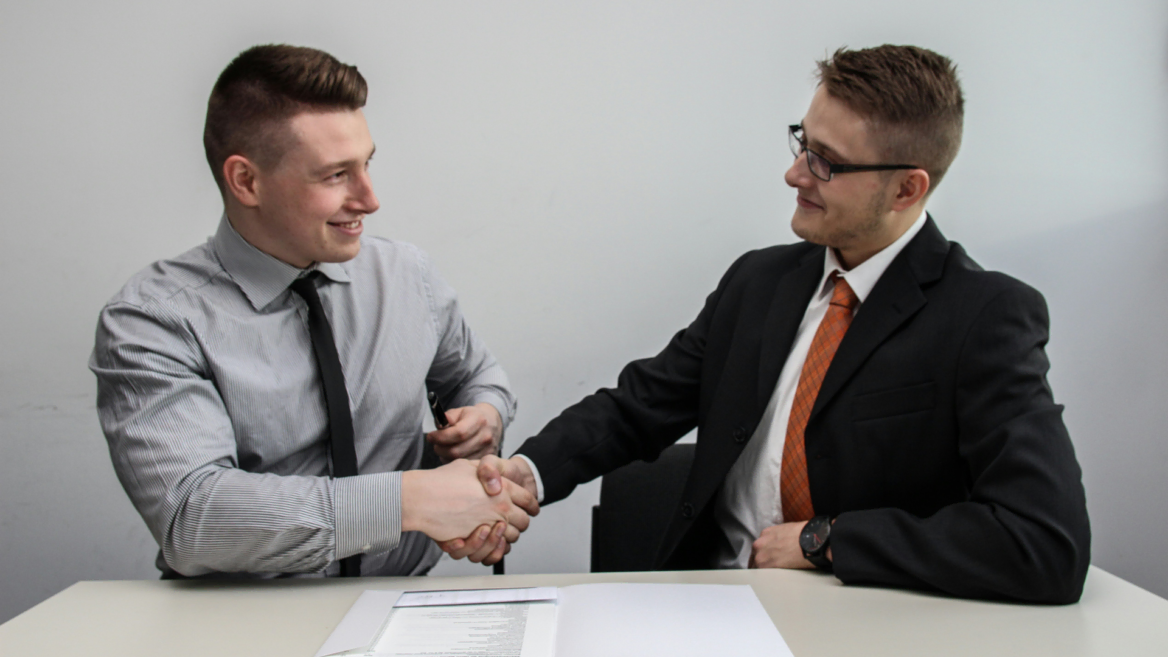 business handshake and document review