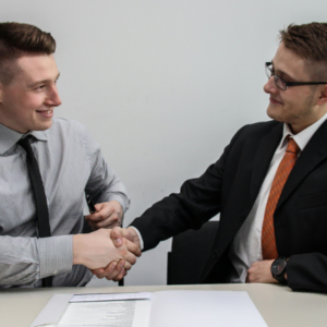 business handshake and document review