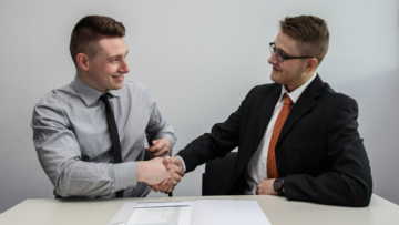 business handshake and document review