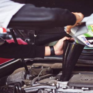 car engine oil refill with funnel