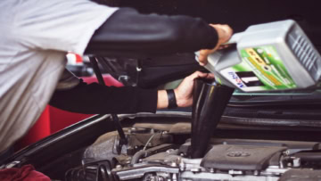 car engine oil refill with funnel