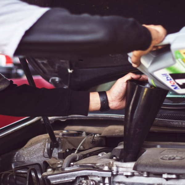 car engine oil refill with funnel