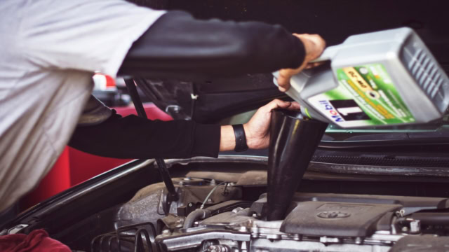 car engine oil refill with funnel