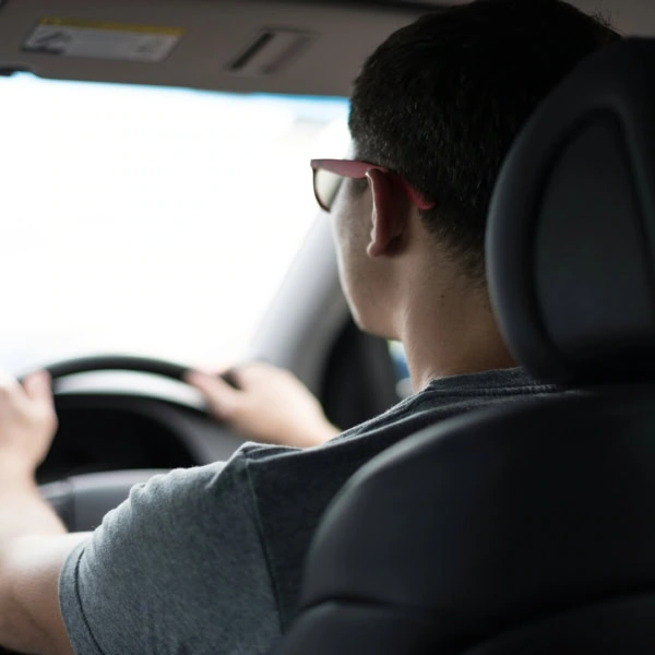 back seat view of driver at the wheel