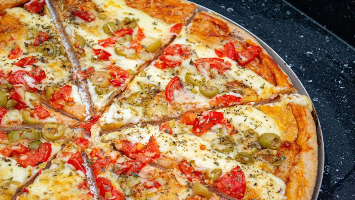 homemade cheese and vegetable pizza on tray