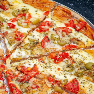 homemade cheese and vegetable pizza on tray