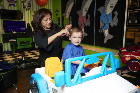 corte infantil en salón temático con silla de auto