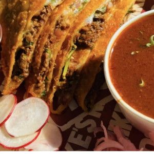 indian fried snacks with curry and chutneys