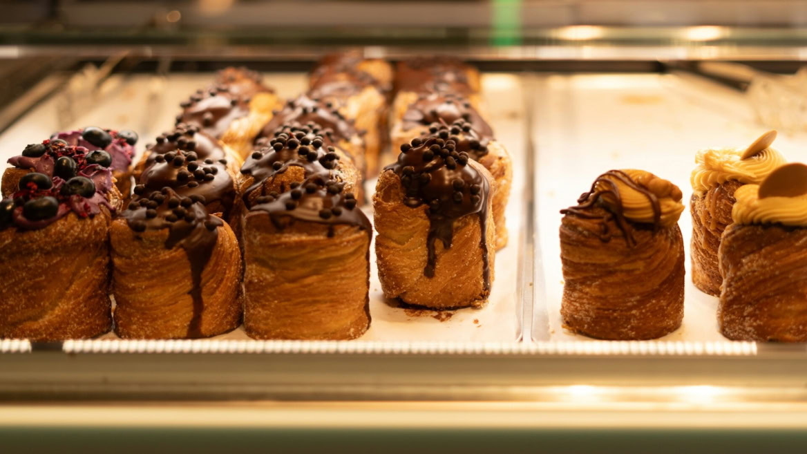 luxury chocolate Éclairs in bakery display case