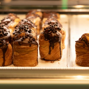 luxury chocolate Éclairs in bakery display case