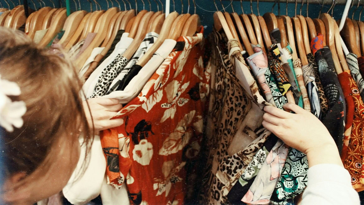 colorful patterned clothes on a crowded rack