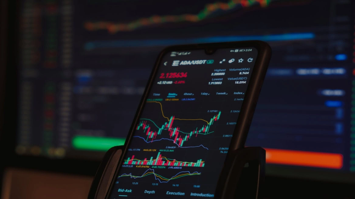crypto trading app on smartphone with ada/usdt chart