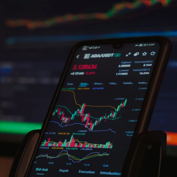 crypto trading app on smartphone with ada/usdt chart