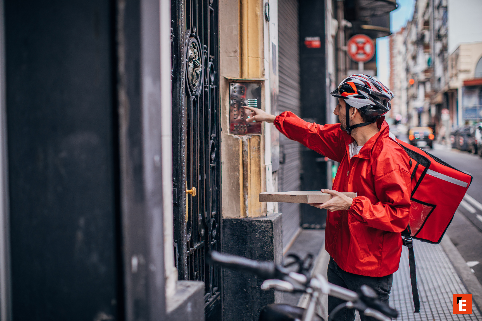 delivery courier at city doorbell, red backpack