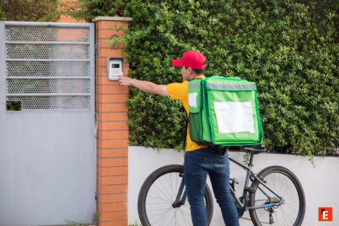 bike courier ringing doorbell at gate