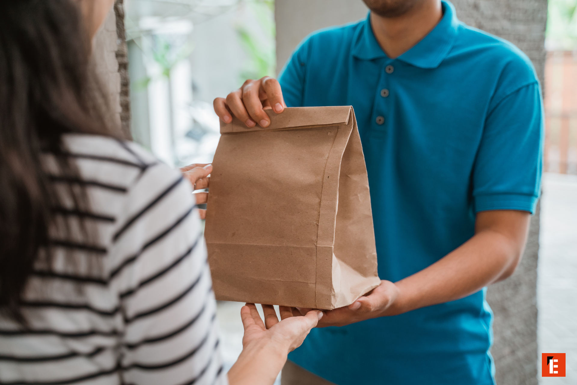 delivery handover of paper bag at doorstep