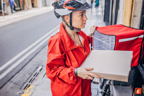 female delivery rider with pizza box and red backpack