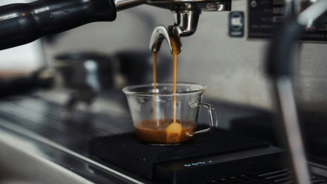 machine à espresso versant un shot dans un verre