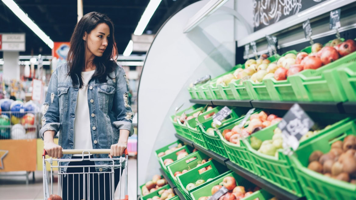 jeune femme choisissant des fruits au supermarché