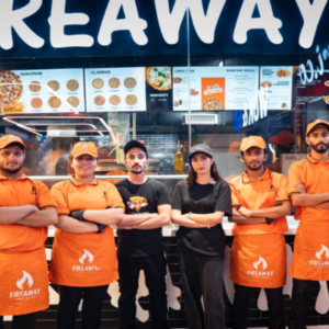 fireaway pizza team poses in orange uniforms