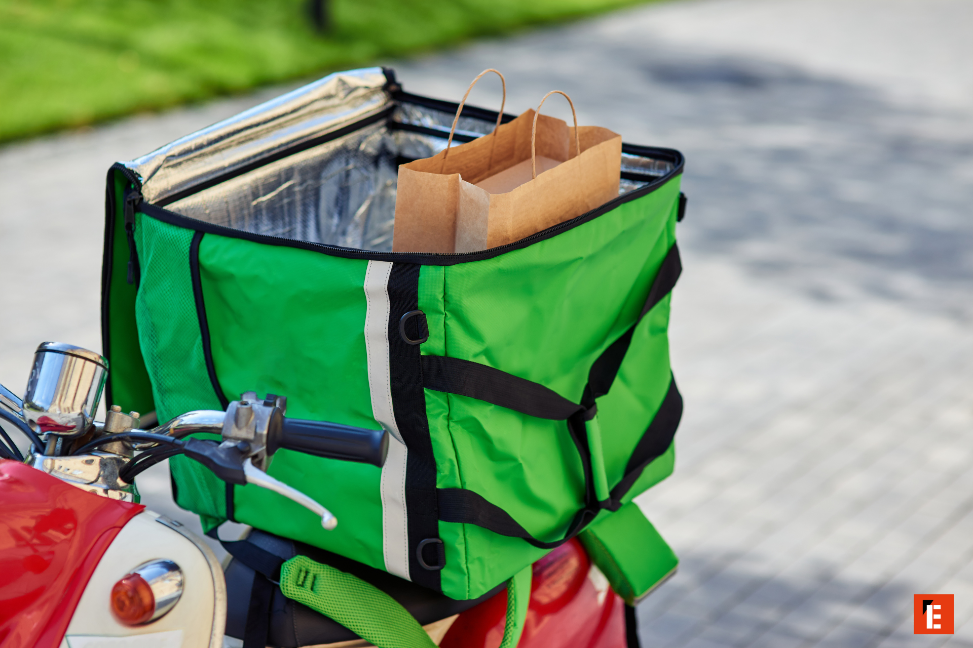 green delivery bag on red scooter