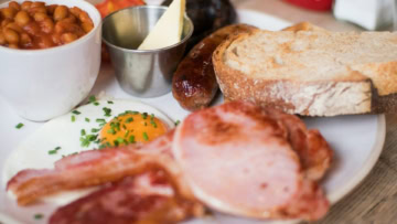 hearty breakfast plate with bacon, egg and toast