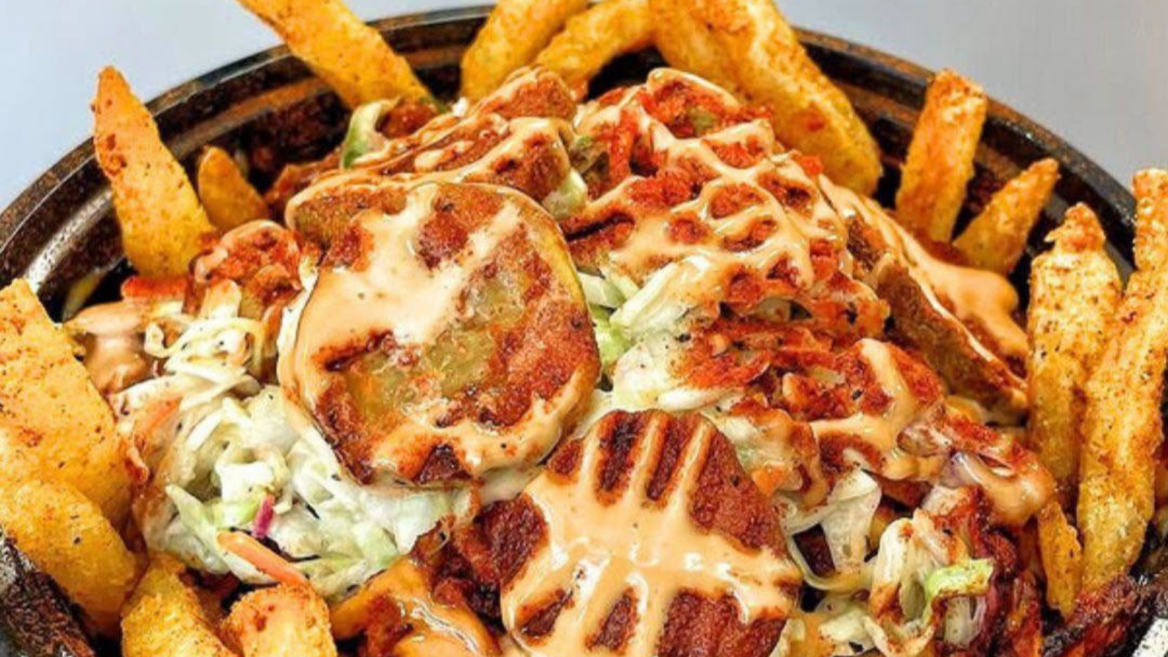 loaded fries bowl with grilled meat and orange sauce