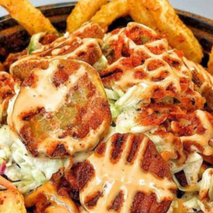 loaded fries bowl with grilled meat and orange sauce