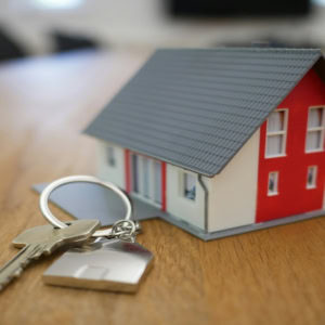 mini house and keys for new home purchase
