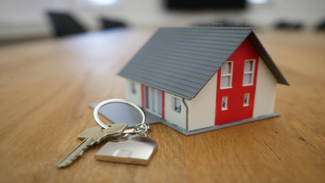 mini house and keys for new home purchase